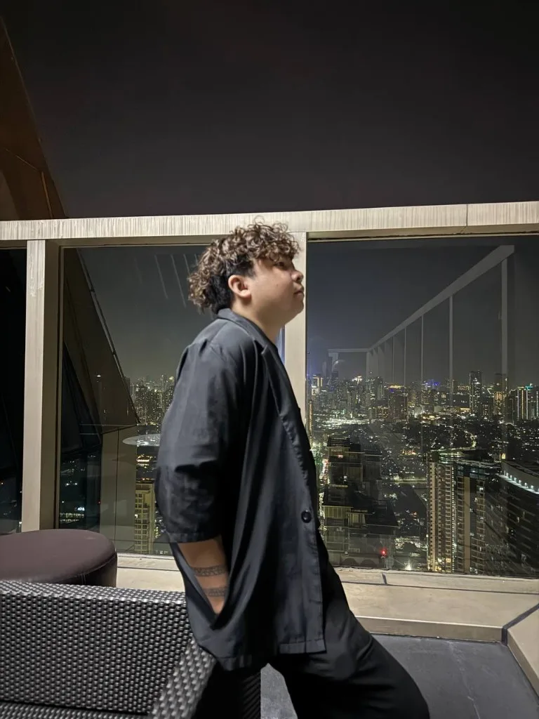 EJ on a rooftop over Metro Manila at night